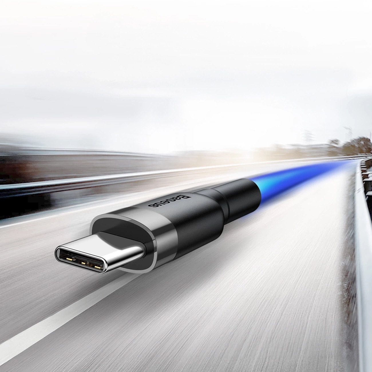 black and gray Baseus Cafule USB-A / USB-C cable moving at the speed of light on a highway.