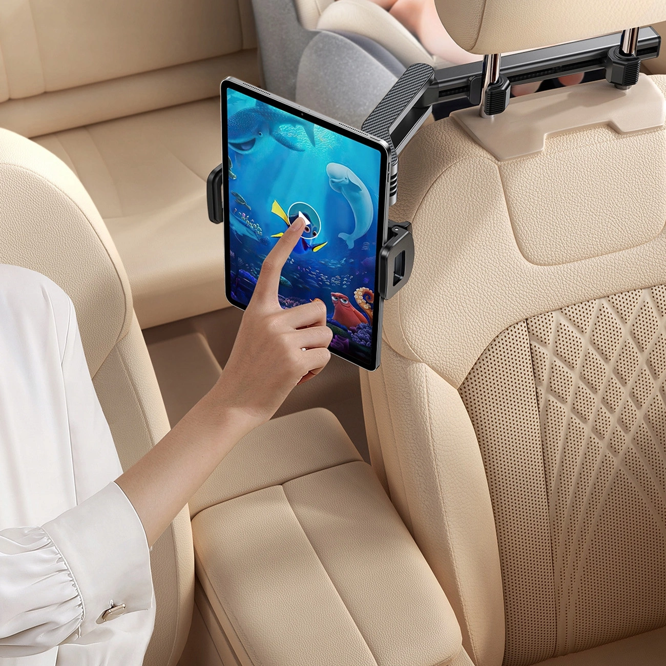 A hand controlling the tablet in the Joyroom JR-ZS369 car headrest holder