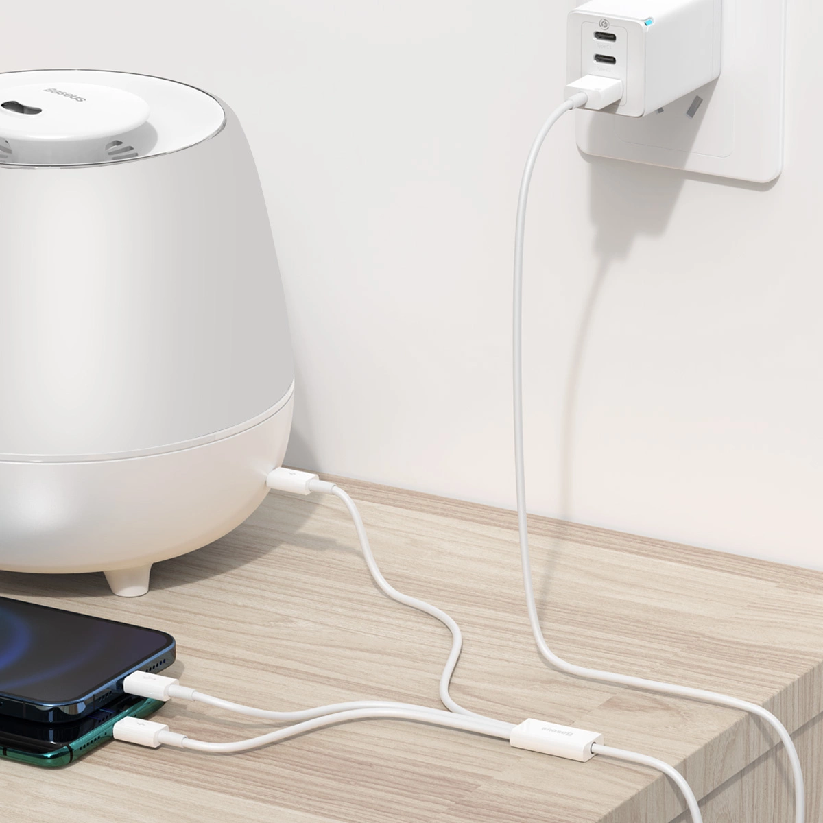 Two phones and a speaker connected to charging simultaneously using a Baseus Superior Series cable