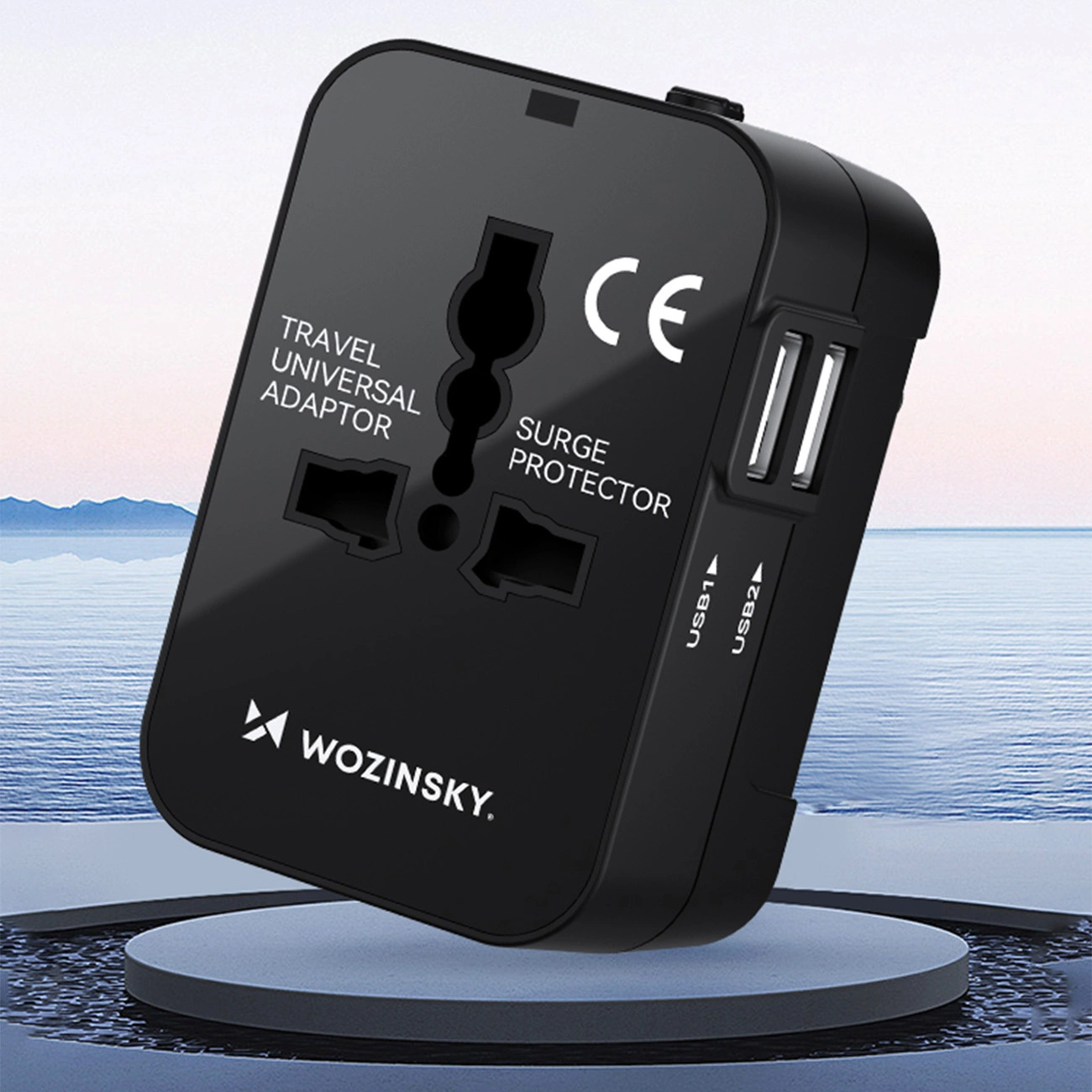 Adapter podróżny Wozinsky WUTWC uniwersalny o mocy do 24W UE / US / AUS / UK / 2x USB-A, w tle wielkie jęzioro oraz góry