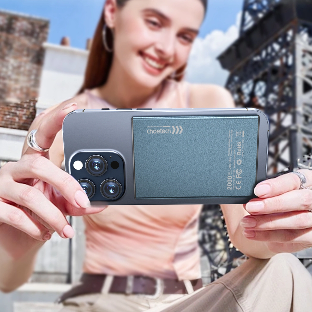 A woman takes a photo with her phone with the Choetech SuperThin B708 ​​Powerbank attached