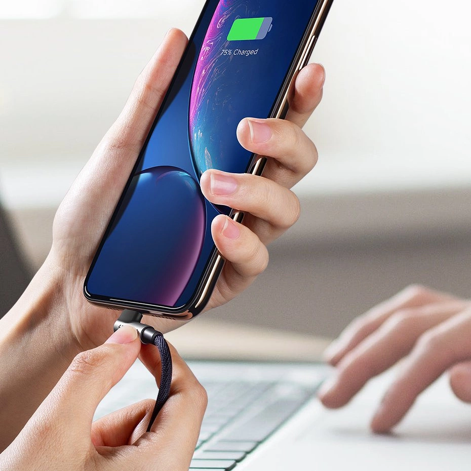 Kobiece dłonie podłączające smartfon do ładowania za pomocą kabla Ugreen US299