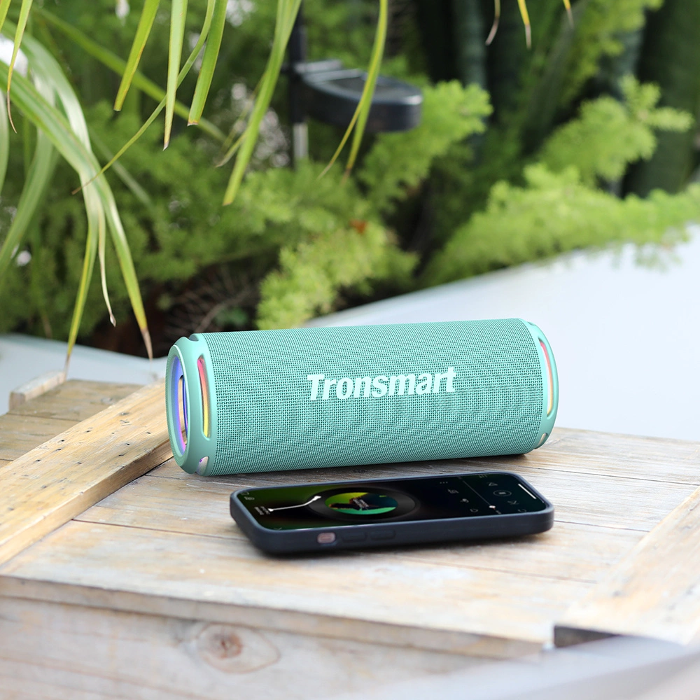 The Tronsmart T7 Lite phone and wireless speaker are lying next to each other.