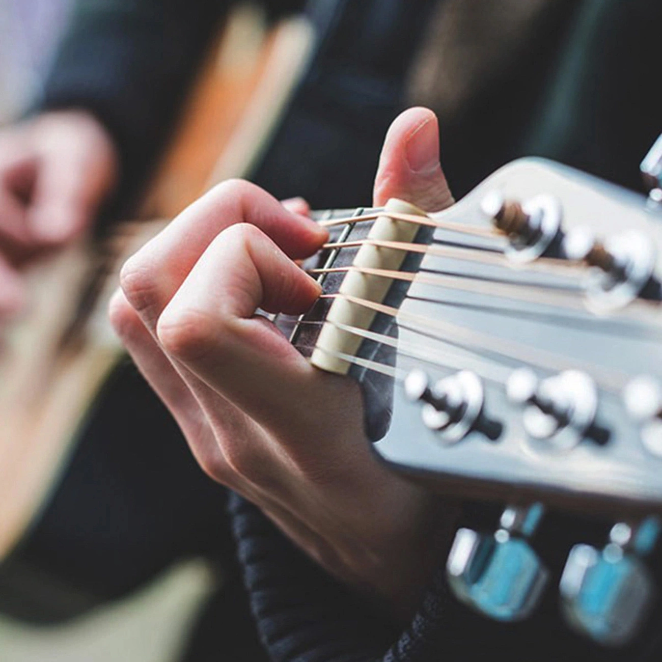 Close-up of the hand of a person playing the guitar