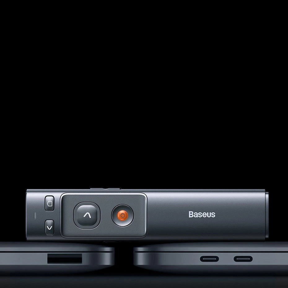 Baseus Orange Dot presentation laser pointer lying on a Macbook Air