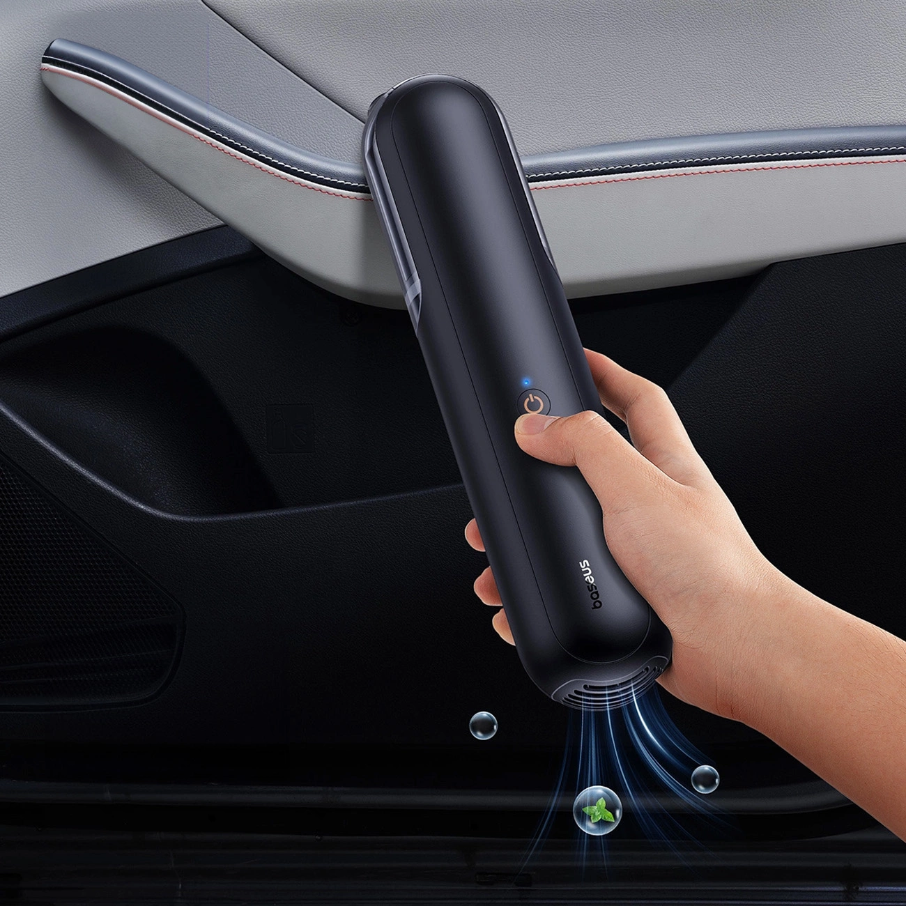 A hand pressing a button on the baseus A0 Pro car vacuum cleaner