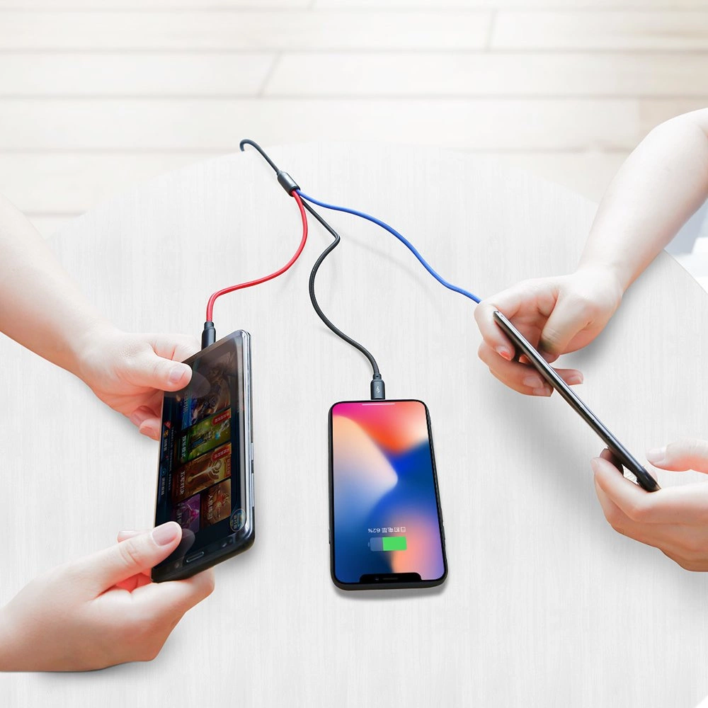 Three phones connected at once to the Baseus Three Primary Colors cable. Two people use two devices while charging.