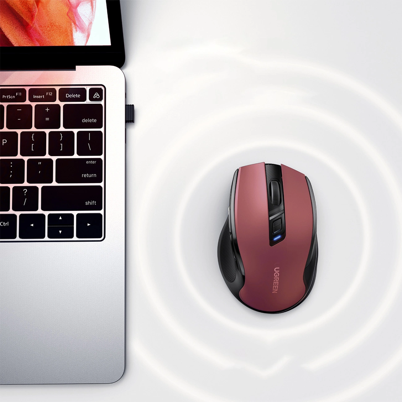 Ugreen MU006 wireless optical mouse connected to a MacBook