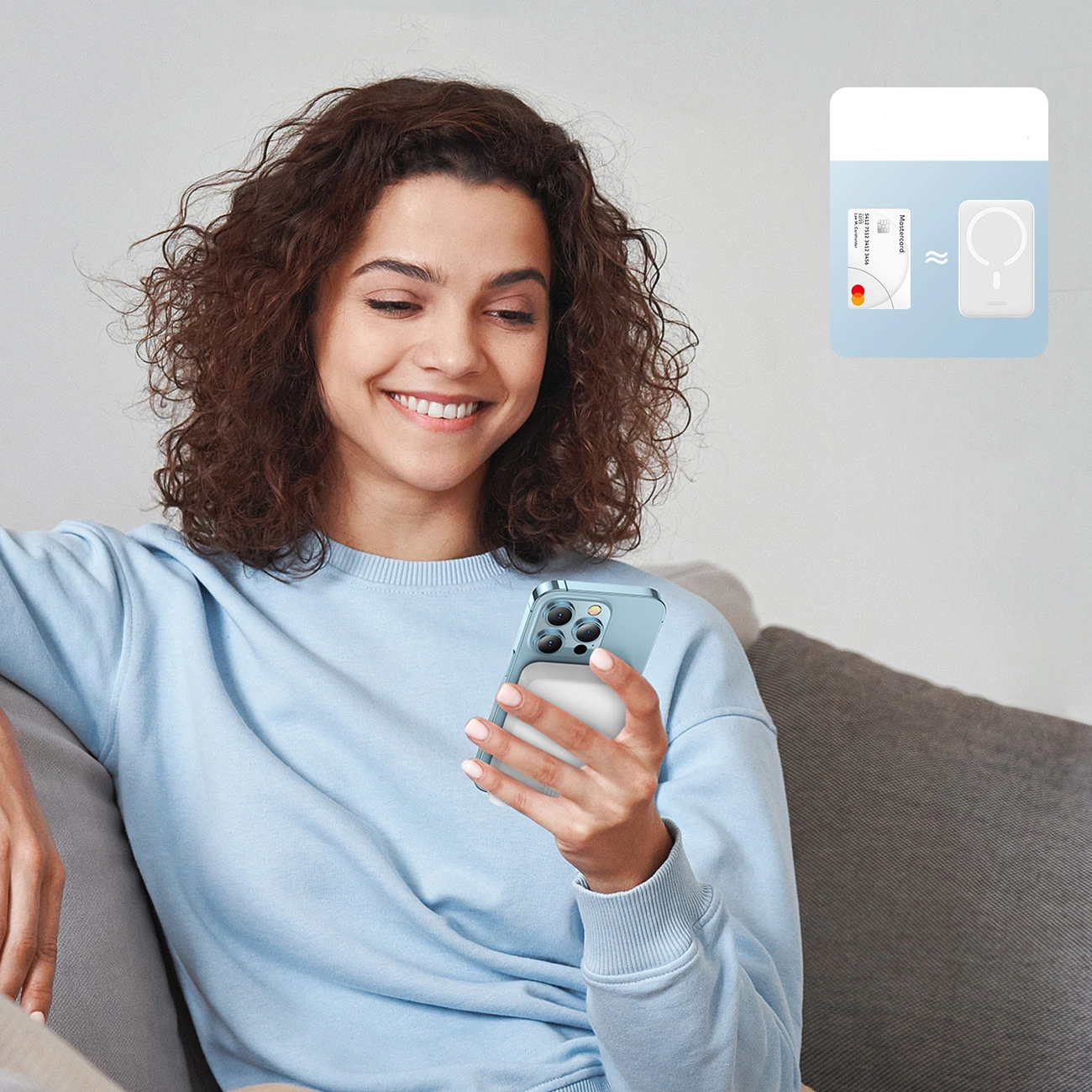 A smiling woman holds a phone with a Baseus Magnetic Mini induction Powerbank 10000mAh 30W attached