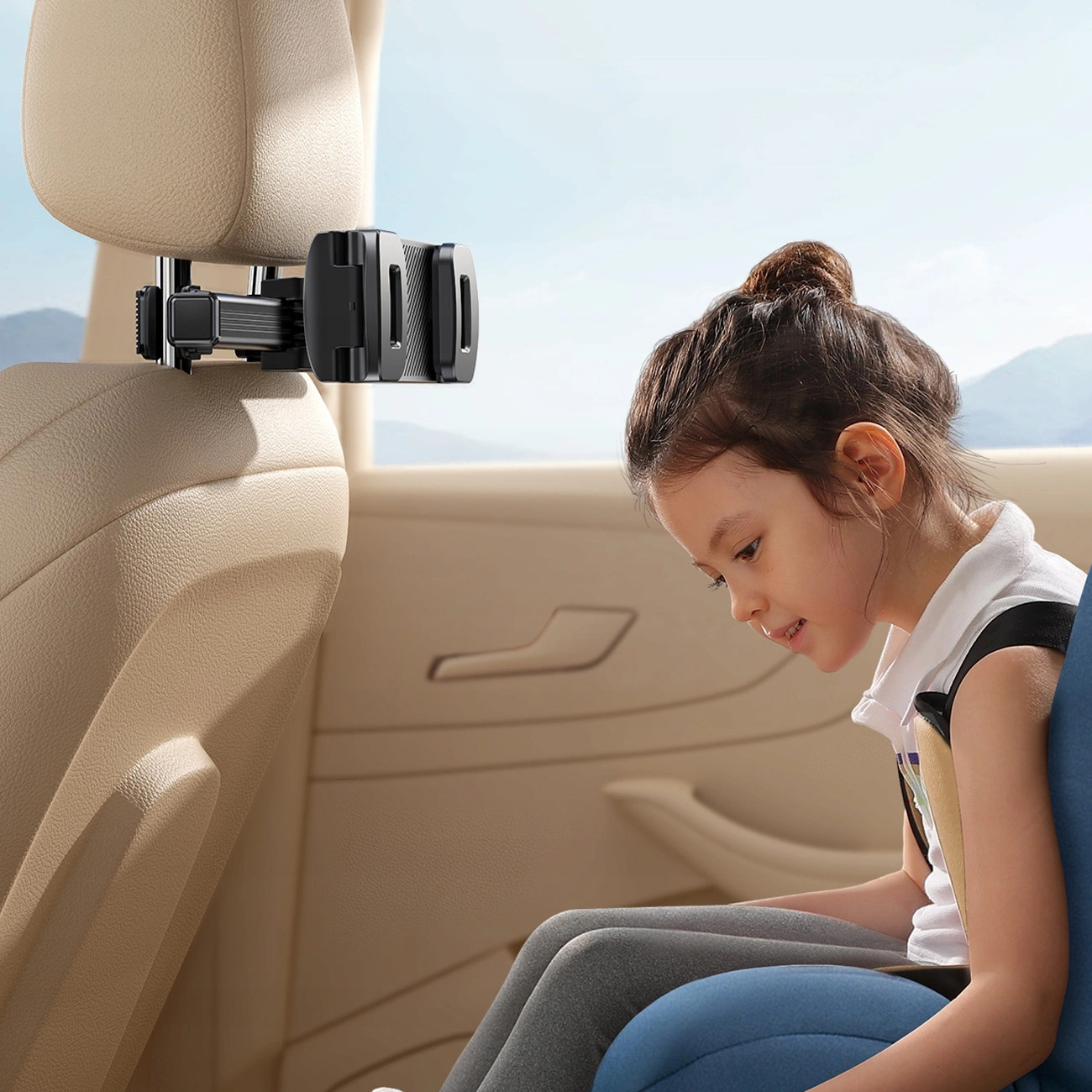 A girl watching on a tablet in a car mounted on the Joyroom JR-ZS369 mount